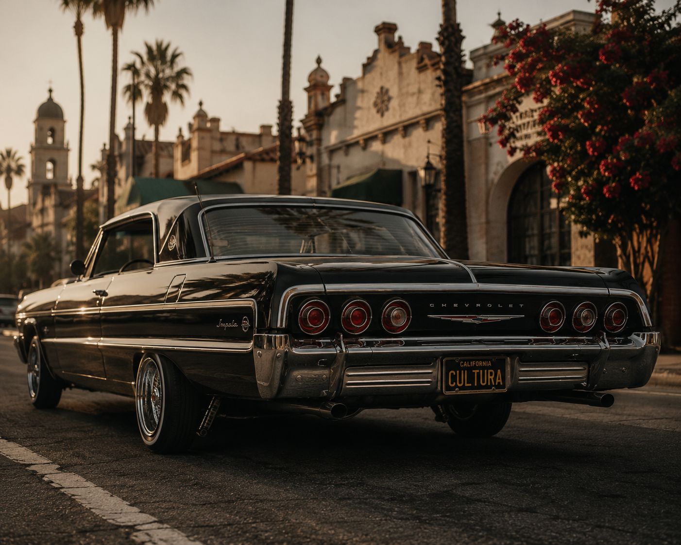 A classic CULTURA lowrider in front of Spanish mission architecture