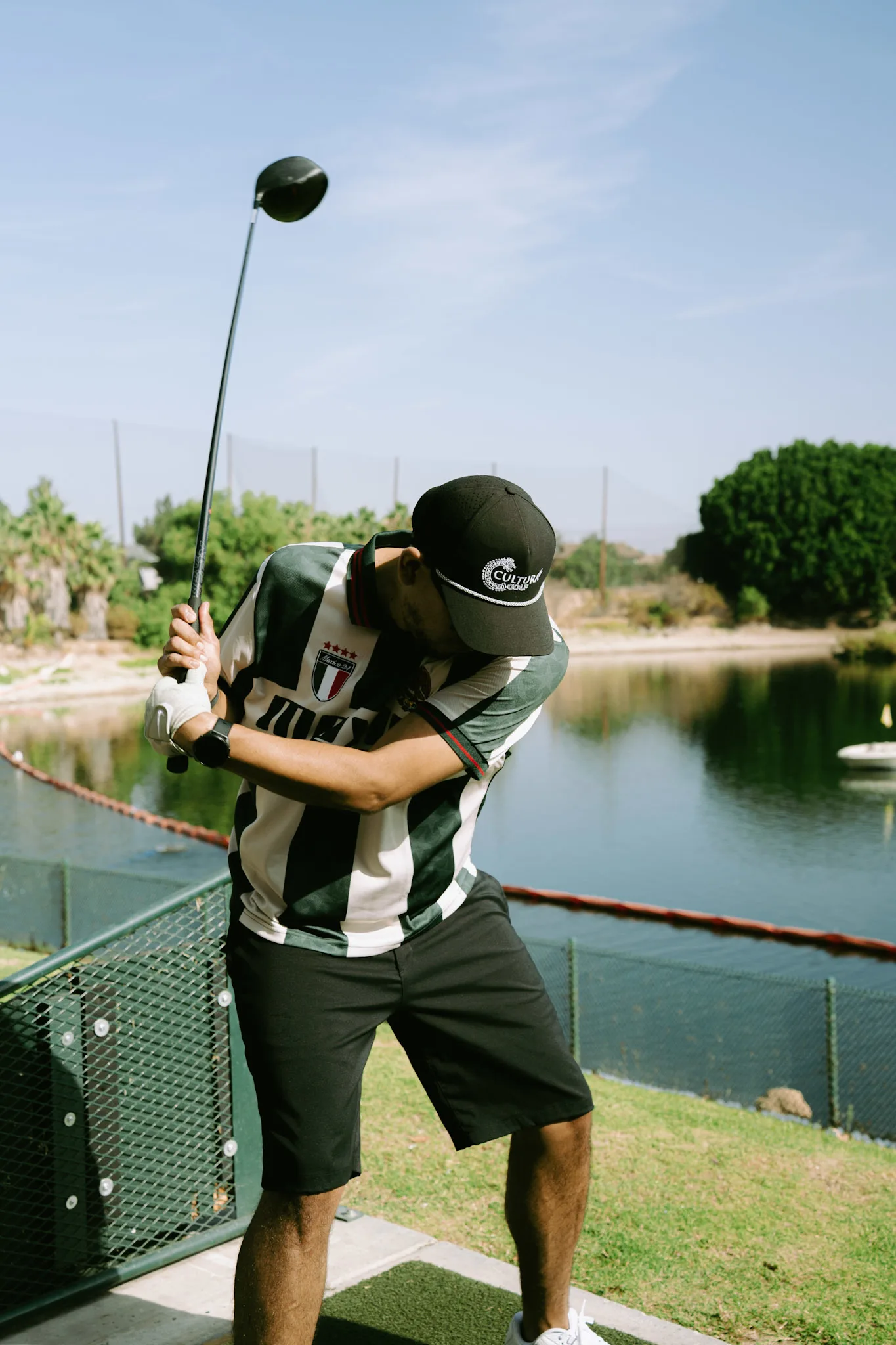A Cultura Golf member mid-swing in a Mexico jersey
