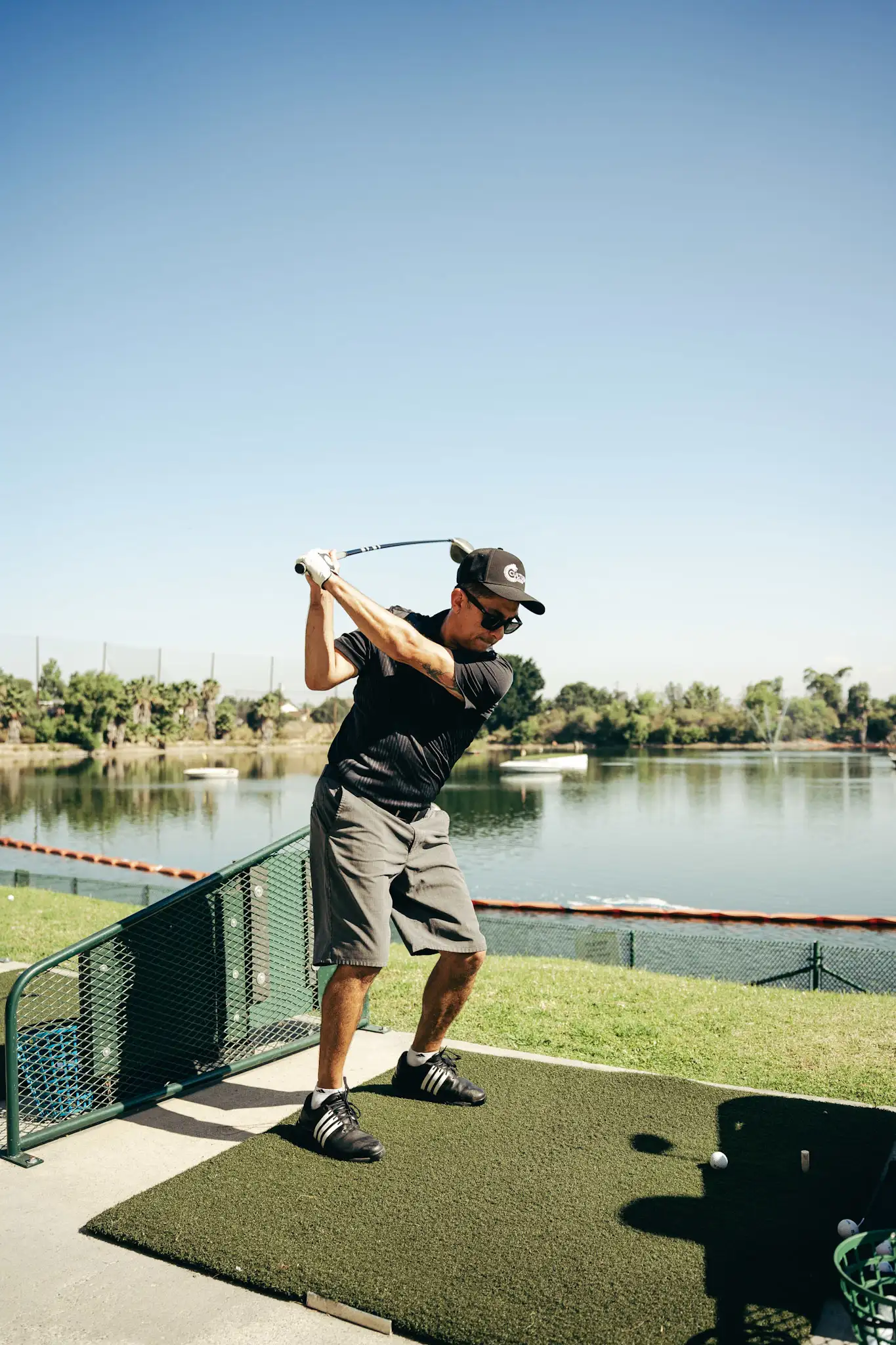 A Cultura Golf member mid-swing at the driving range